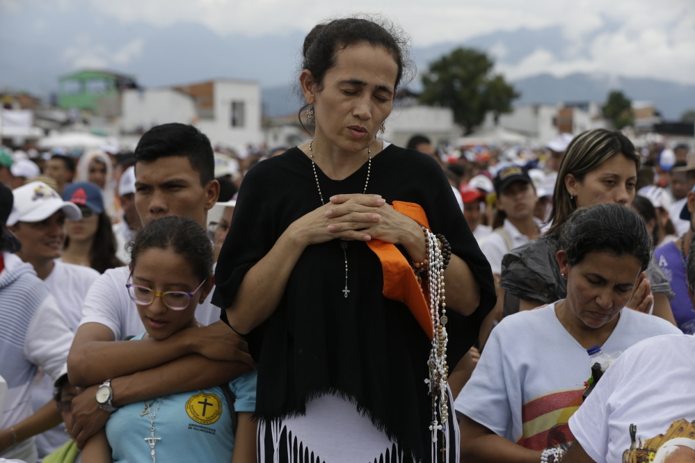 A woman prays during a Mass celebrated by Pope Francis in Villavicencio, Colombia, on Friday, as he continues a five-day trip to that country.
Associated Press/Ricardo Mazalan