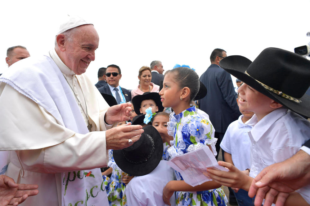 Pope Francis is welcomed by a group of children upon his arrival in Villavicencio, Colombia, on Friday.