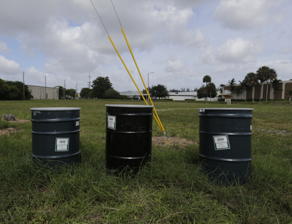 Barrels containing chemical waste sit in a field designated by the EPA as a polluted Superfund site called Anodyne North Miami Beach.