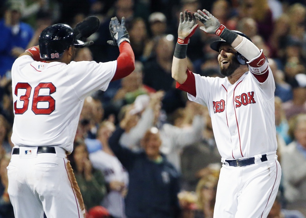 Boston's Dustin Pedroia, right, celebrates his two-run home run that also scored Eduardo Nunez, left, during the first inning against Tampa Bay on Saturday night. The Red Sox won, 9-0.