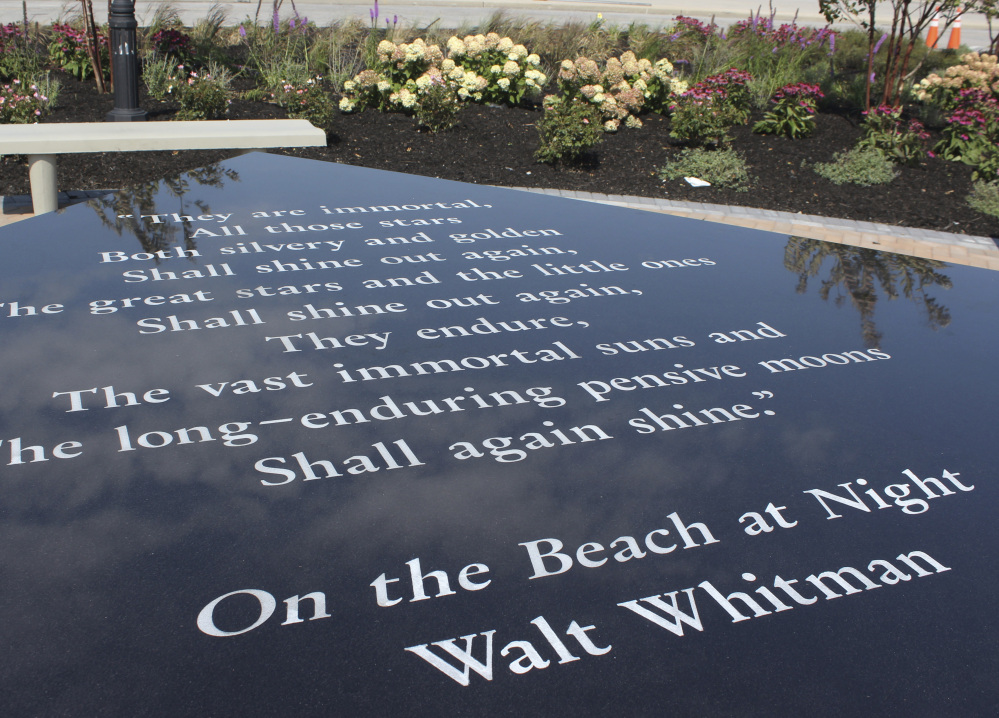 A table containing the Walt Whitman poem "On the Beach at Night" is part of a memorial being dedicated in Hempstead, N.Y., Monday. The memorial also includes names of people who died of illnesses from working at Ground Zero. 