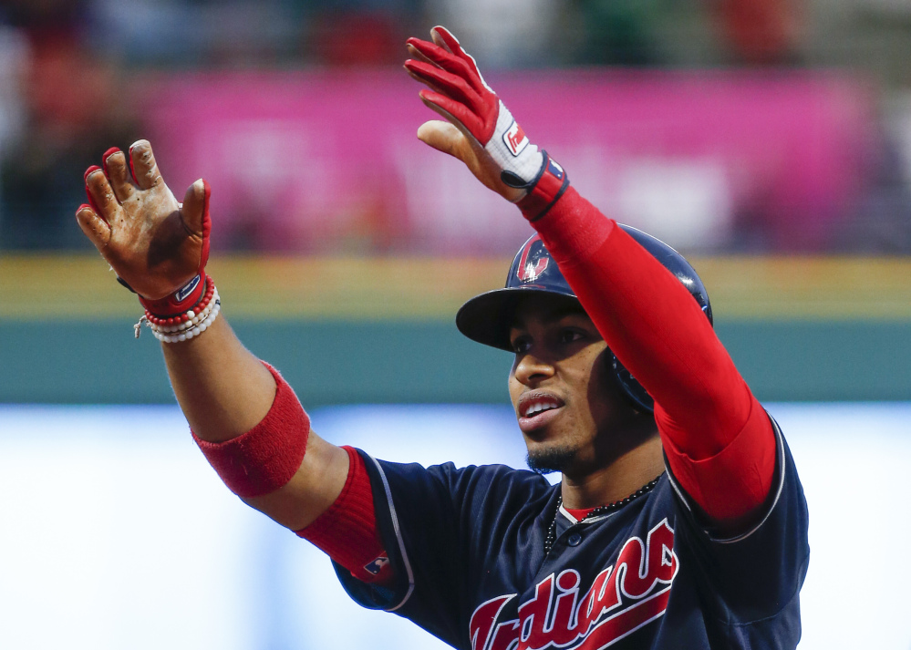 Cleveland's Francisco Lindor celebrates after leading off the bottom of the first with his 30th home run to help the Indians win their 20th straight game, 2-0, on Tuesday in Cleveland.