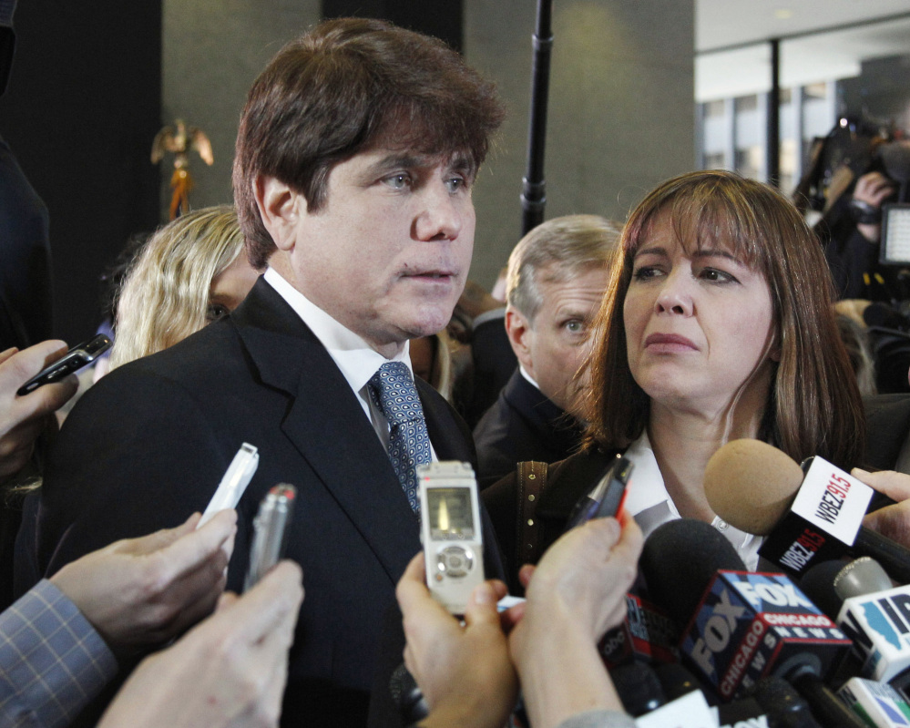 Former Illinois Gov. Rod Blagojevich, speaks to reporters as his wife, Patti, listens in Chicago in 2011. Blagojevich said he spends his time mopping floors while serving a federal sentence after corruption convictions. In a recent interview from a Colorado prison, he still maintains his innocence.
Associated Press