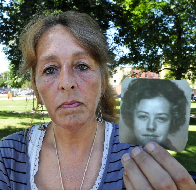 Honey Rourke of Lewiston holds a 1970 photograph of her mother, Pauline Rourke, on July 26. Pauline Rourke disappeared in 1976 and is believed to have been murdered by Albert Cochran, who died recently in prison.