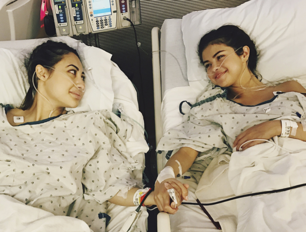 In image posted on Selena Gomez's Instagram account Thursday, Gomez, right, holds hands with actress Francia Raisa in a hospital.
Selena Gomez via AP