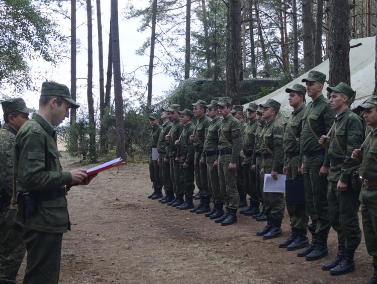 Belarus' Col. Alexander Prokopenko, left, reads an order to start drills at a training ground at an undisclosed location in Belarus on Thursday as war games with Russia begin.