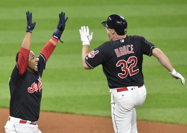 Jay Bruce of the Indians, right, is congratulated by teammate Edwin Encarnacion after hitting the winning RBI single in the 10th inning against the Royals on Thursday in Cleveland.
