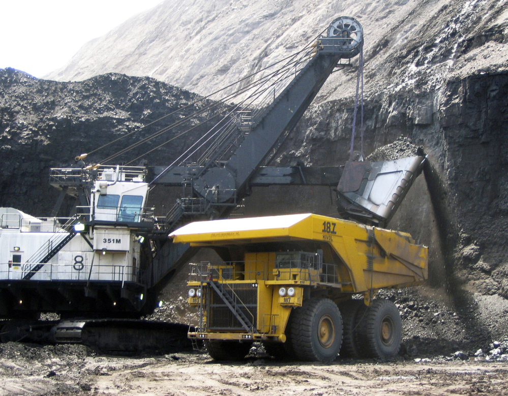 A shovel dumps coal into a truck at the Black Thunder mine in Wright, Wyo. A federal appeals court has sided with environmentalists trying to block mining at the two biggest coal mines in the U.S.