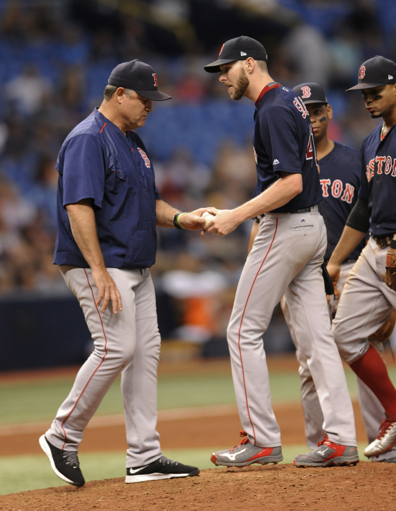 Boston Red Sox manager John Farrell, left, pulls starter Chris Sale during the sixth inning Friday night. Sale allowed four runs on six hits and three walks while striking out nine in 5   innings of work.