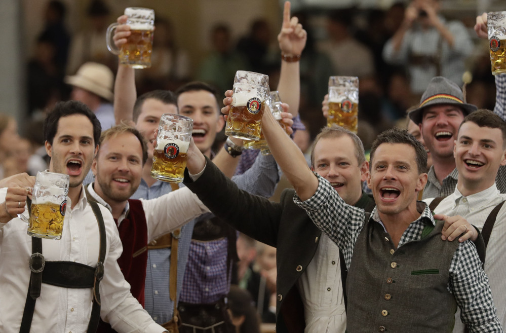 Young men celebrate the opening of the 184th Oktoberfest beer festival in Munich, Germany, on Saturday.