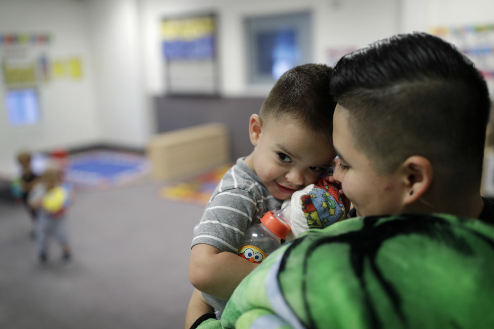 Precyla Escobar holds her 2-year-old son, Zeke, at the McCarran International Child Development Center in Las Vegas. Those who work outside of the 9-to-5 shift are lost in the national conversation over access to child care and early education.