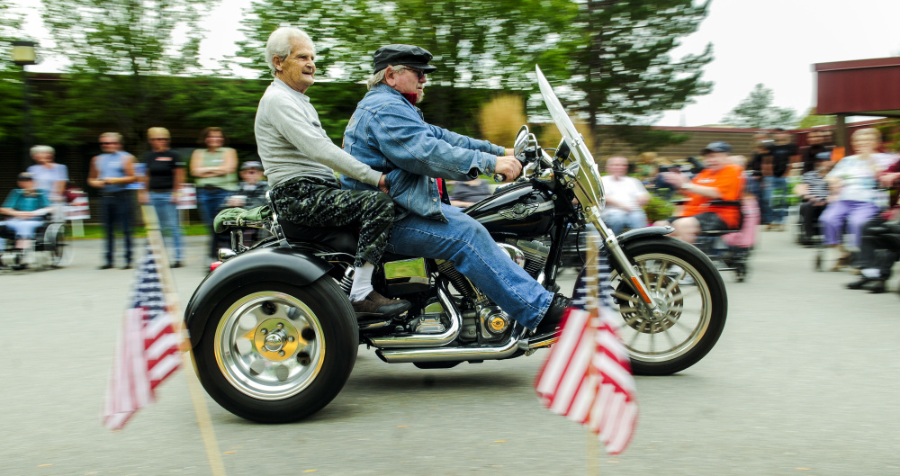 Alfred King gets a ride on the back of Alfred Tuttle's 2003 Harley-Davidson Dyna Super Glide trike Saturday at the Maine Veterans Home in Augusta. Tuttle, of Madison, gave several residents rides around the parking lots before a fundraiser ride took off for Lewiston.