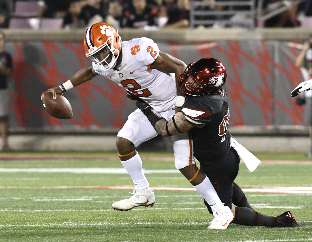 Clemson's Kelly Bryant is tackled by Louisville's James Hearns on Saturday night in Louisville, Ky. Clemson won 47-21.