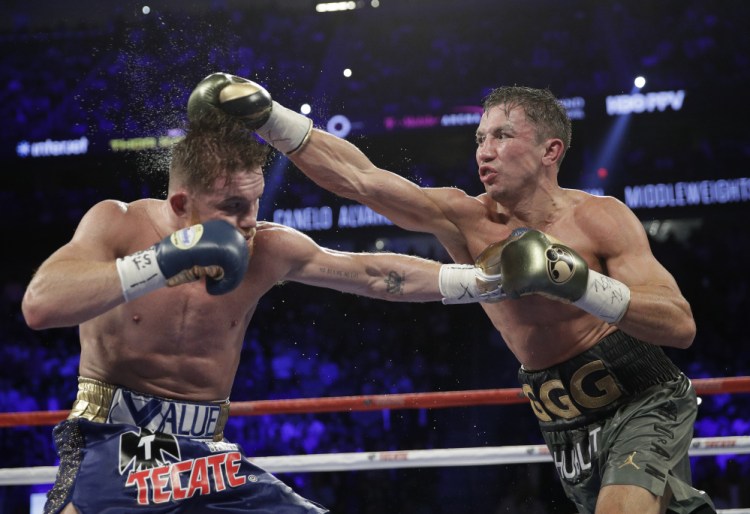 Gennady Golovkin, right, connects with a right to Canelo Alvarez during their middleweight title fight Sunday night in Las Vegas. The pair fought to a 12-round draw.