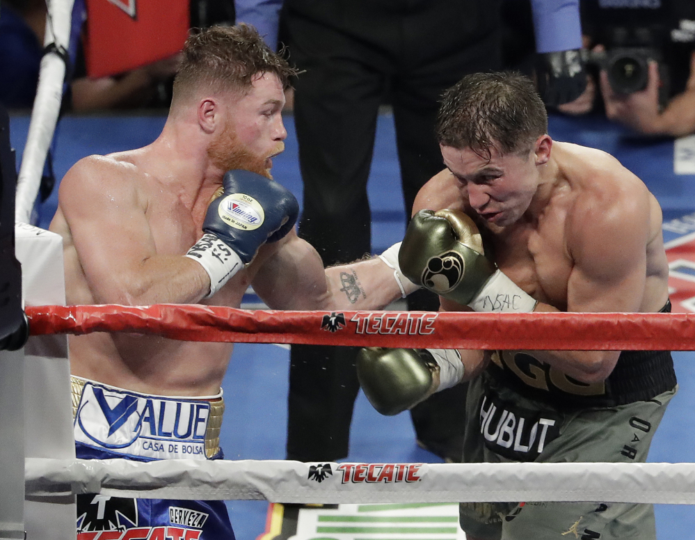 Canelo Alvarez, left, fights Gennady Golovkin during a middleweight boxing bout Saturday night in Las Vegas. The pair are expected to schedulde a rematch soon.