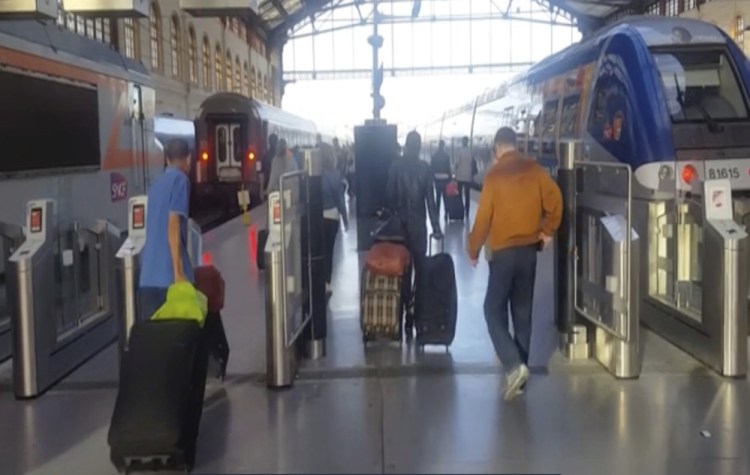 This image taken from video shows passengers inside Marseille-Saint-Charles railway station in Marseille, France, on Sunday.