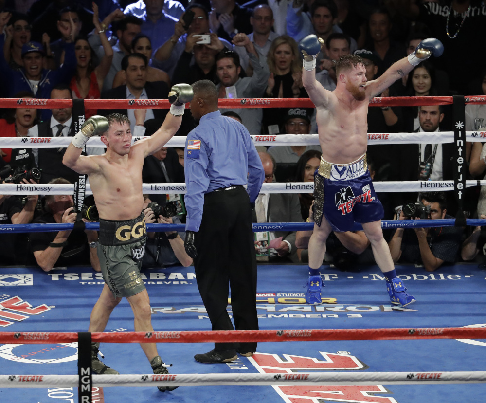 Canelo Alvarez, right, and Gennady Golovkin celebrate after their middleweight title fight Saturday in Las Vegas. The fight was called a draw.