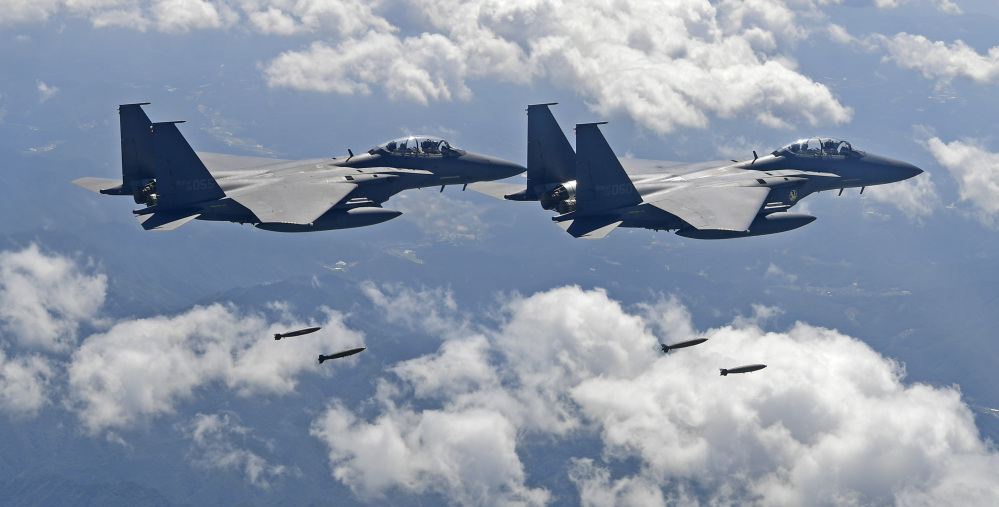 In this photo provided by South Korea Defense Ministry, South Korean F-15K fighter jets drop bombs as they fly over the Korean Peninsula during joint drills with the U.S.