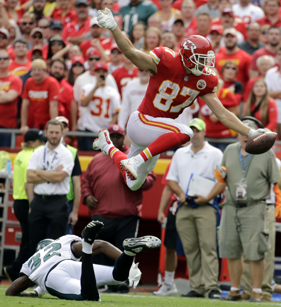 Chiefs tight end Travis Kelce leaps over Eagles cornerback Rasul Douglas to score a touchdown on a 15-yard reception during Kansas City's 27-20 win Sunday. Kelce caught eight passes for 103 yards as he helped the Chiefs improve to 2-0.
