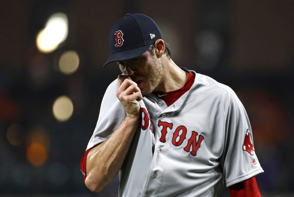 Red Sox starter Doug Fister wipes his face as he walks off the field after giving up three runs in the second inning. Fister's outing ended in the third inning, after he gave up five earned runs and walked five batters.