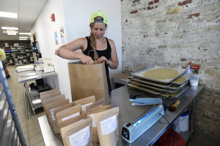 Nina Murray of Mill Cove Baking Co. packages her crackers.