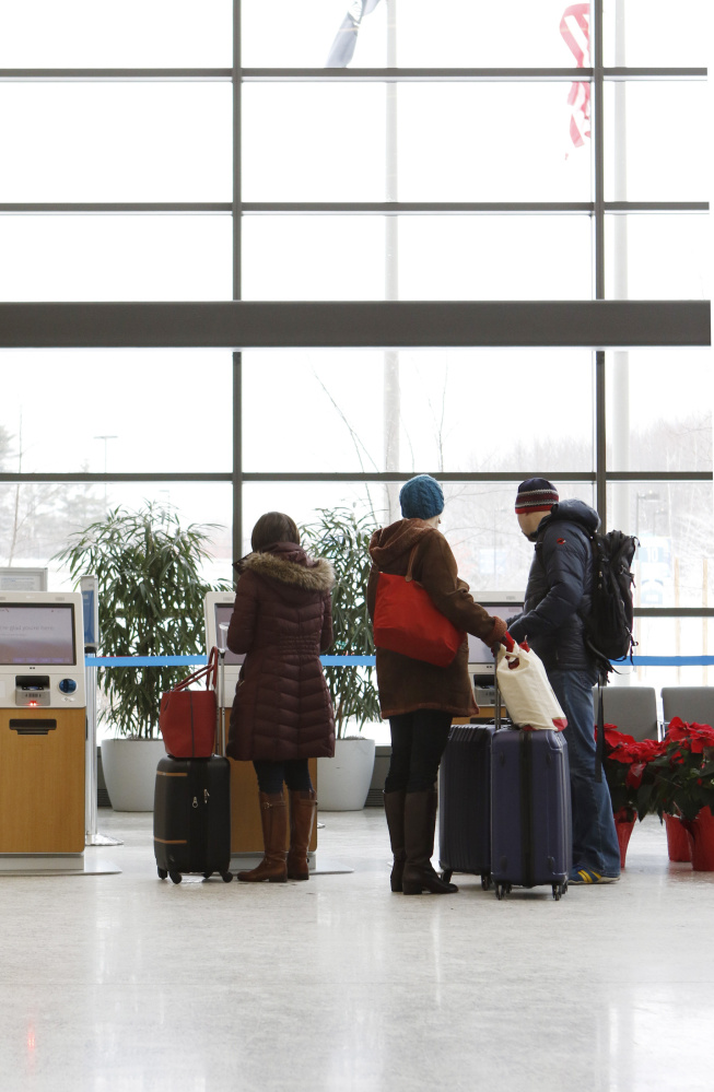 Travelers check in for flights at the Portland International Jetport in 2015. A record number of passengers used the jetport in 2017.
