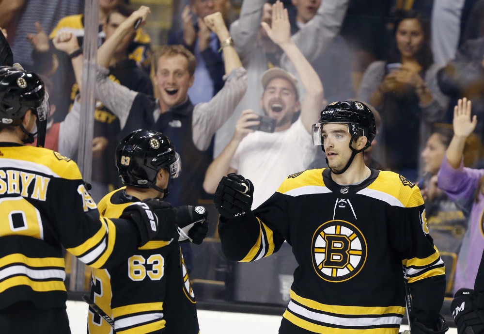 Boston's Kenny Agostino, right, celebrates his game-winning goal with Brad Marchand during overtime of a 2-1 win over Philadelphia on Thursday in Boston.