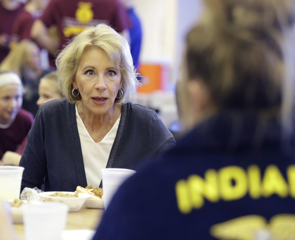 Secretary of Education Betsy DeVos meets with residents in   Charlottesville, Ind. Devos has eased Obma-era regulations that crack down on fraudulent practices at for-profit universities.