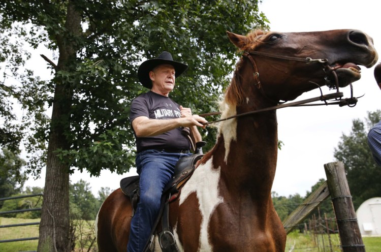 U.S. Senate candidate Roy Moore rides a horse to vote at the Gallant Volunteer Fire Department during the Alabama Republican primary in August.