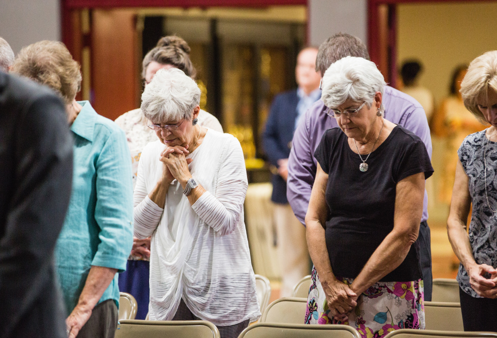 People pray before a Moore rally in Florence, Ala. Moore often quotes from the Bible as he campaigns.
Washington Post/Nathan Morgan