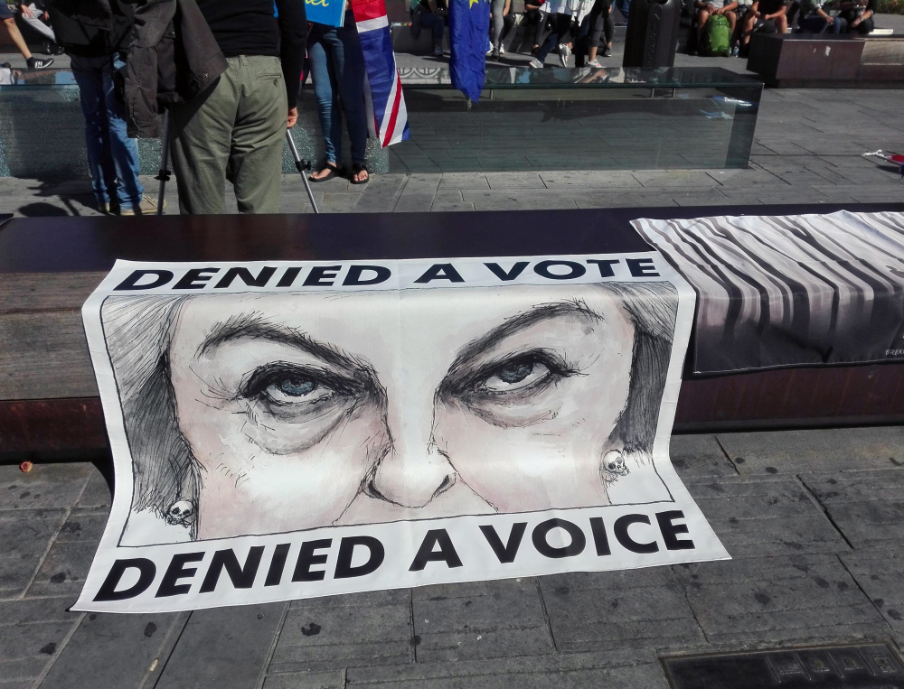 A poster showing British Prime Minister Theresa May is displayed during a protest staged by a group of U.K. citizens living in Italy, in Florence, Italy, on Friday.