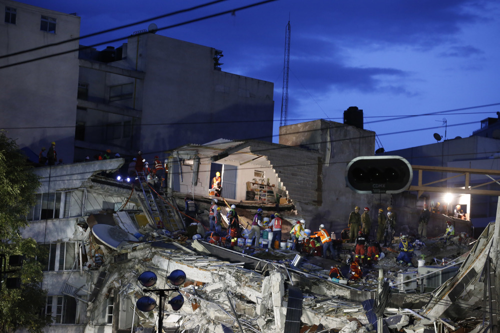 Rescuers race to save people believed to be still alive inside a collapsed office building in the Roma Norte neighborhood of Mexico City on Friday night, three days after a 7.1 magnitude earthquake. Hope mixed with fear Friday in Mexico City, where families huddled under tarps and donated blankets, awaiting word of their loved ones trapped in rubble.