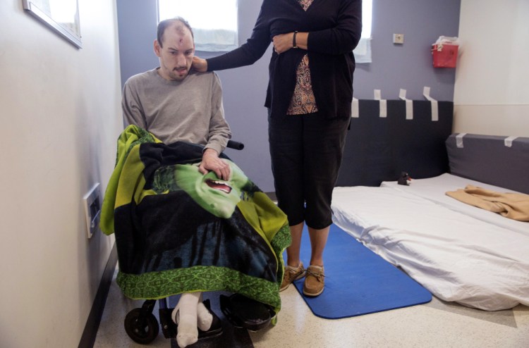 For two months now, Mark Madore, 34, who has developmental disabilities and experiences seizures, has been staying in this room with makeshift padding in the emergency department at Redington-Fairview General Hospital in Skowhegan. He was evicted from his group home in Embden after his mother, Cathy Madore, right, had one of his direct care workers administer medical marijuana to treat his seizures.