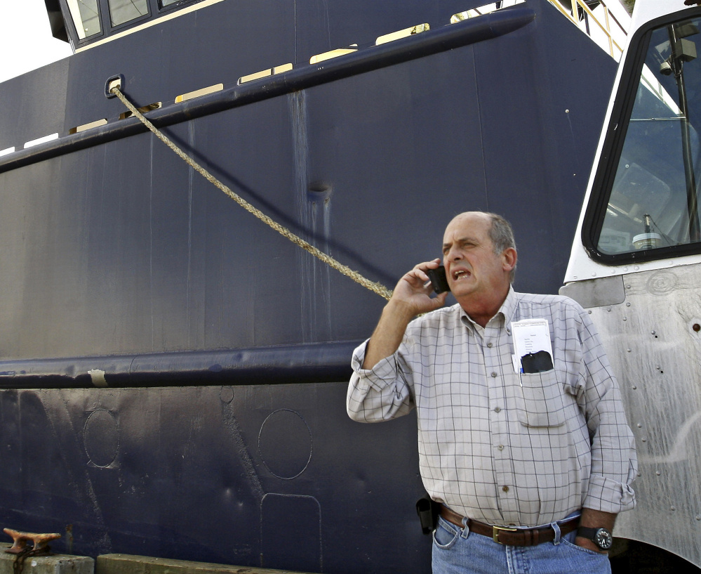Carlos Rafael, the U.S. fishing magnate known as The Codfather, talks on the phone at Homer's Wharf near his herring boat F/V Voyager in New Bedford, Mass., in 2014.