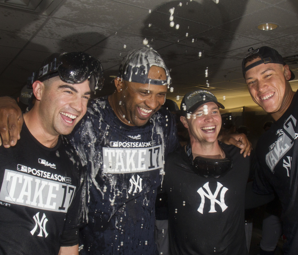 The Yankees celebrated earning a wild-card berth, while the Red Sox are choosing to wait.