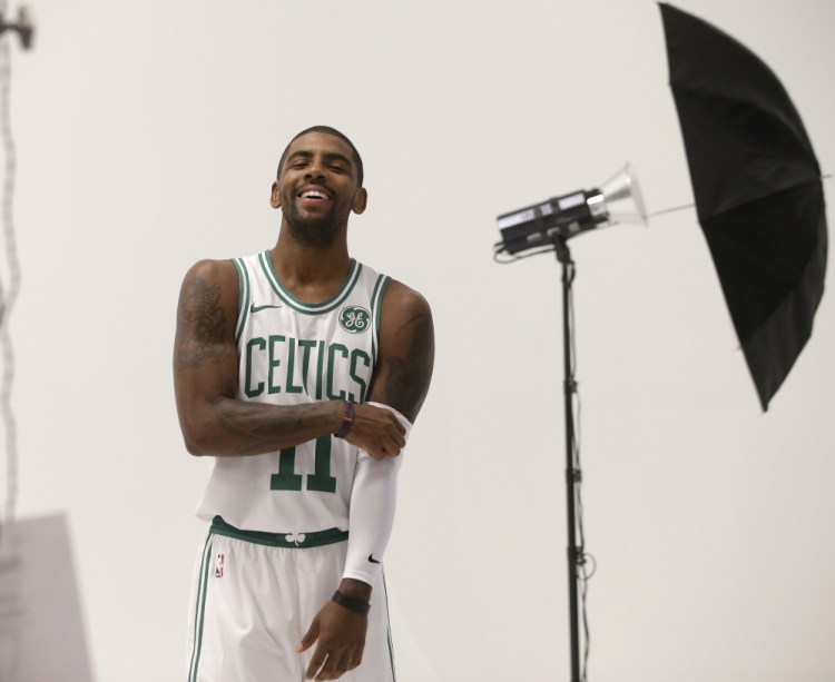 Kyrie Irving smiles during a photo shoot at Celtics media day Monday in Canton, Massachusetts. Irving joins Gordon Hayward as key additions to the Eastern Conference finalists.