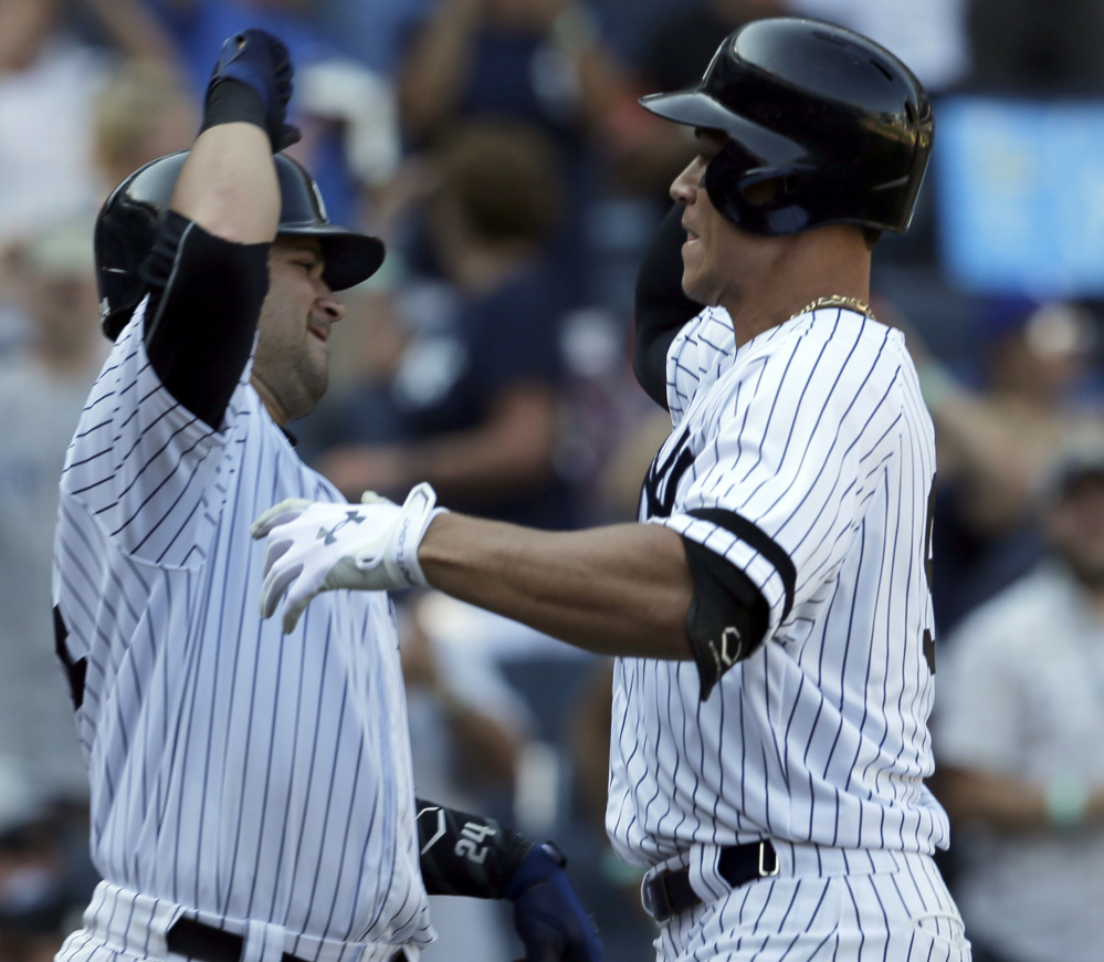 Aaron Judge of the New York Yankees, right, celebrates with teammate Gary Sanchez in the seventh inning after hitting his 50th home run of the season, setting a major league record for homers by a rookie. The Yankees defeated the Kansas City Royals, 11-3.
