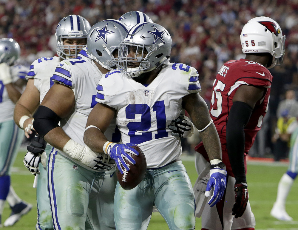 Cowboys running back Ezekiel Elliott (21) celebrates his 8-yard touchdown run against the Cardinals in the second half Monday night in Glendale, Ariz. Elliott rushed for 80 yards in the game.