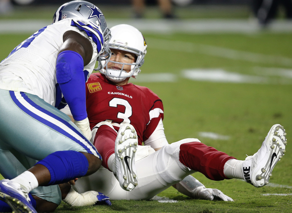 Cardinals quarterback Carson Palmer looks at Dallas defensive end Demarcus Lawrence after being sacked in the second half.