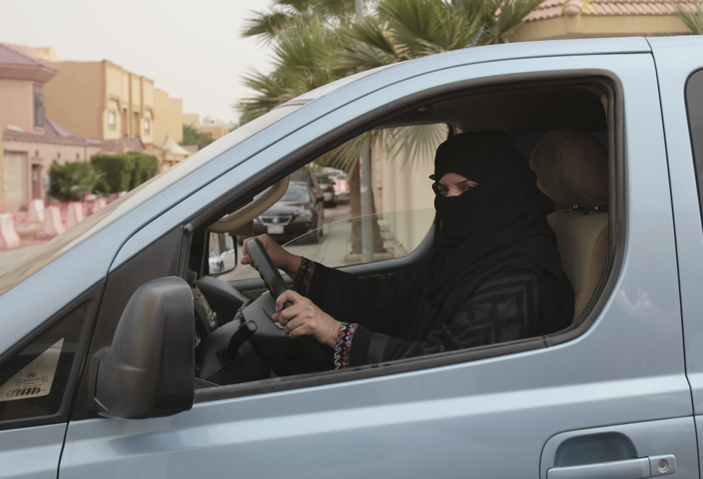 A woman drives a car in Riyadh as part of a 2014 campaign to defy Saudi Arabia's ban on women driving. The kingdom said Tuesday that women can drive starting next summer.