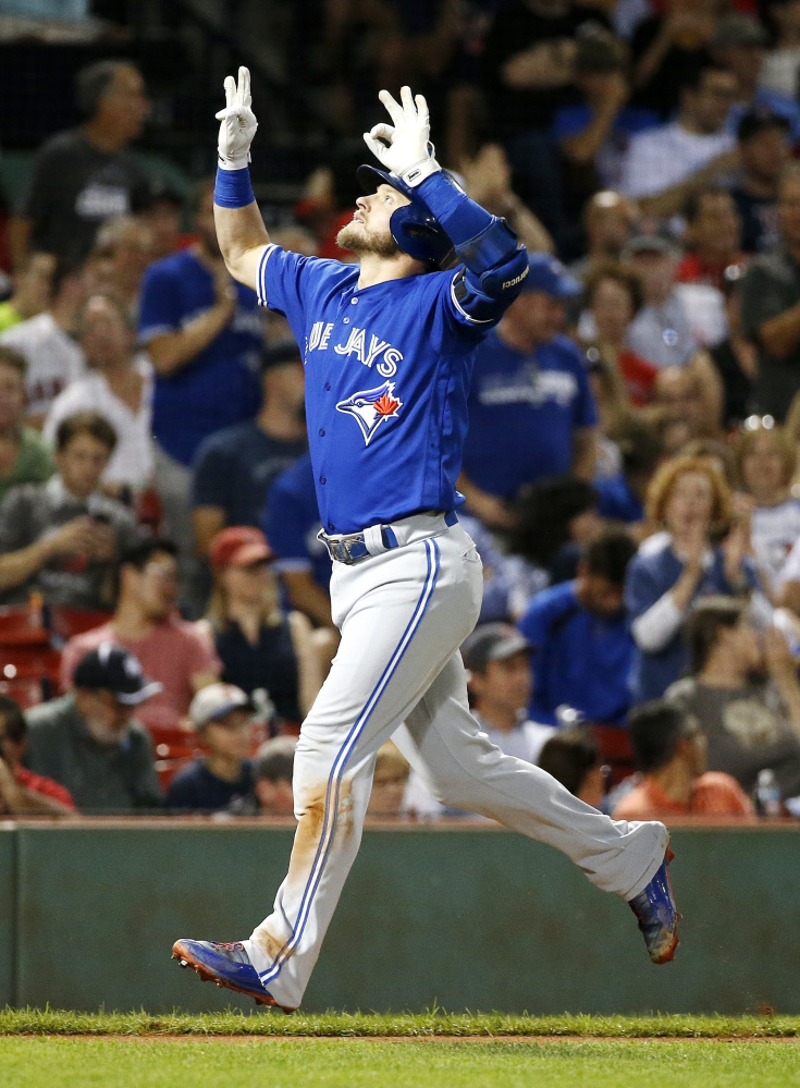 Toronto Blue Jays' Josh Donaldson celebrates his solo home run during the third inning of a baseball game against the Boston Red Sox in Boston, Tuesday, Sept. 26, 2017. ()
