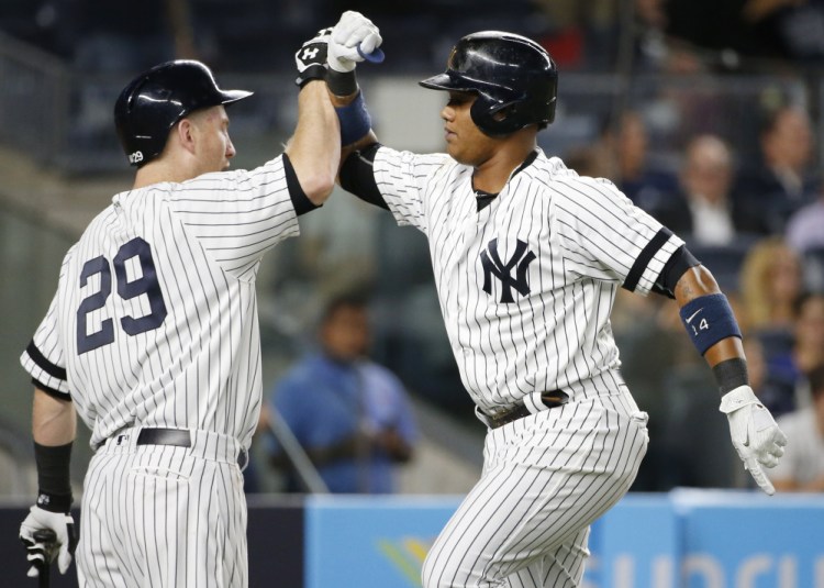 Starlin Castro, right, celebrates his solo home run with on-deck batter Todd Frazier during the second inning of Tuesday's game in New York. The Yankees beat the Rays, 6-1.