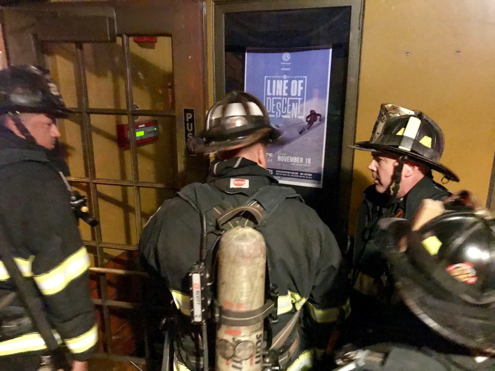Portland firefighters respond to a smoke alarm set off Tuesday night at the State Theatre during a performance by the Pixies.