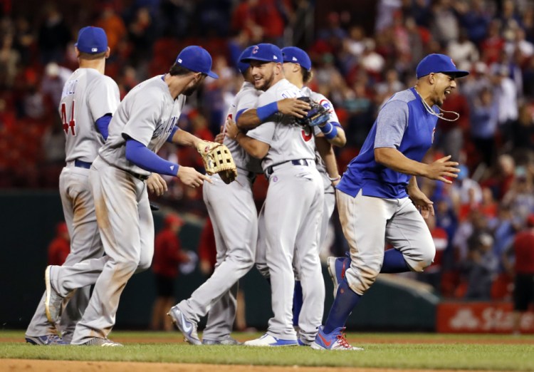 Cubs players celebrate after they defeated the Cardinals 5-1 on Wednesday night in St. Louis to clinch the National League Central title.