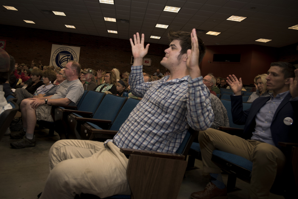 Ryan Murphy of Portland shows his agreement by waving his hands during a Democratic gubernatorial candidates' forum Thursday night at the University of Maine at Augusta. The event was hosted by the Kennebec County Democratic Party.