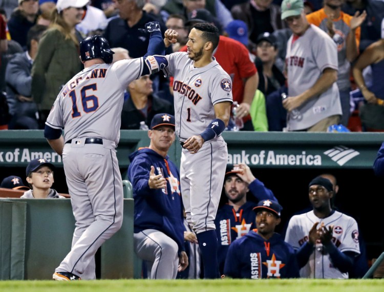 Houston's Brian McCann is congratulated by Carlos Correa after his solo home run off Red Sox reliever Austin Maddox in the sixth inning Thursday night at Fenway Park.