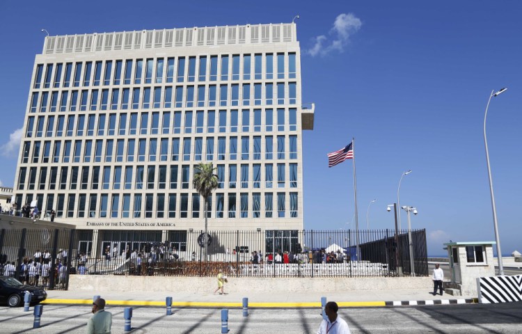 FILE - In this Aug. 14, 2015, file photo, a U.S. flag flies at the U.S. embassy in Havana, Cuba. Senior U.S. officials say the United States is pulling roughly 60 percent of its staff out of Cuba and warning American travelers not to visit due to "specific attacks" that have harmed U.S. diplomats. (AP Photo/Desmond Boylan, File)