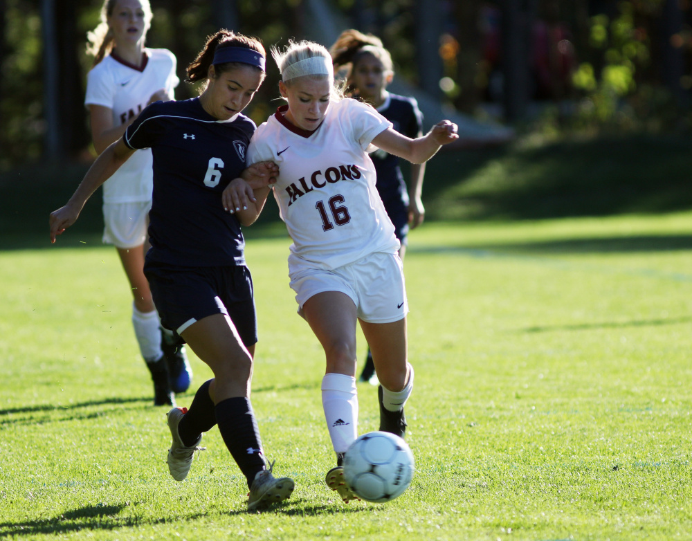Sophia Harpool of Yarmouth, left, and Tara Migliaccio of Freeport compete for the ball. Yarmouth improved its record to 10-0 and dropped the Falcons to 6-3.