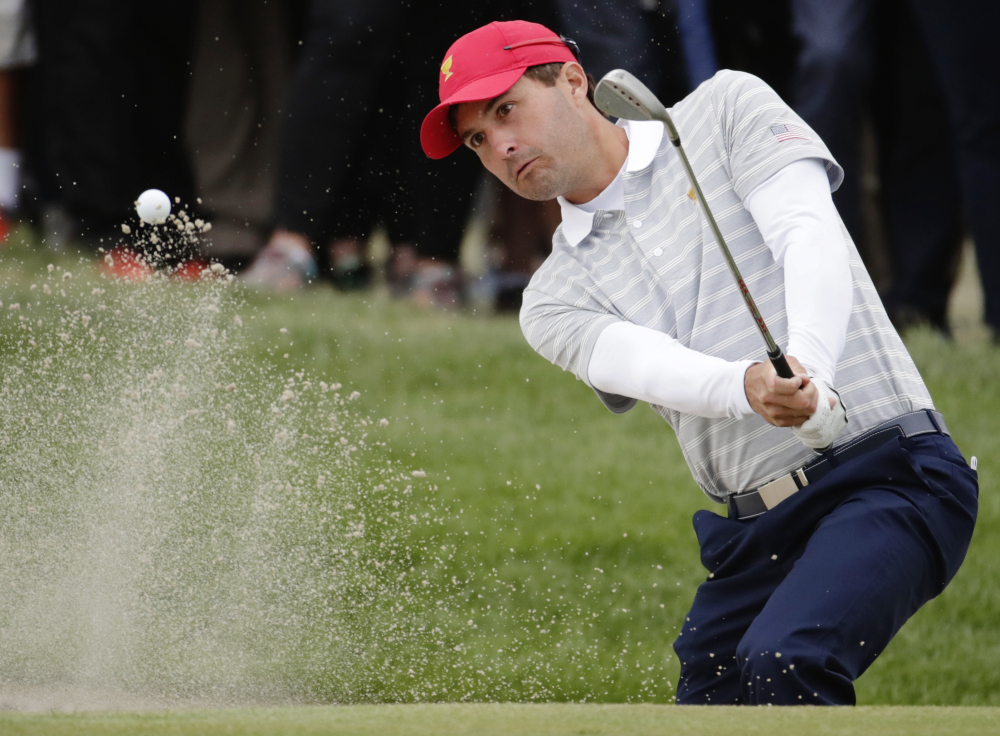 Kevin Kisner hits out of a bunker on the 16th hole on Saturday during the third day of the Presidents Cup at Liberty National Golf Club in Jersey City, N.J. The United States team needs just one point out of Sunday's 12 matches to clinch the Cup