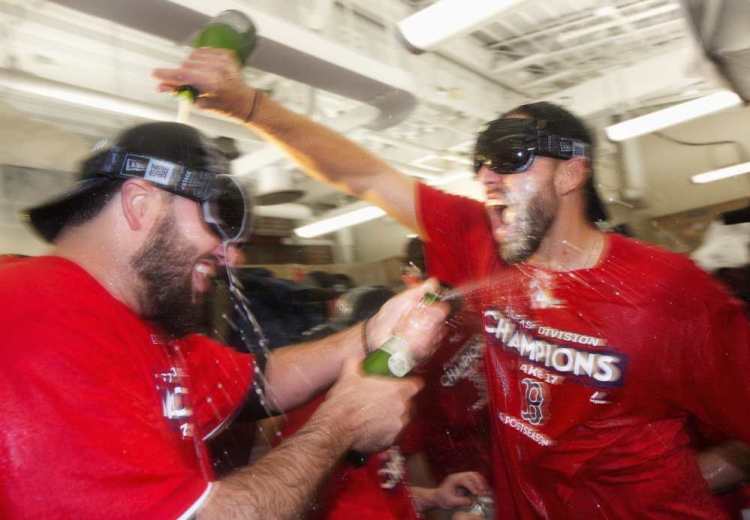 Boston's Matt Barnes, right, celebrates in the clubhouse with teammates after they defeated the Houston Astros 6-3 to clinch the American League East title in Boston on Saturday.